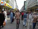 Tall chick walking through a shopping crowd with no clothes at all