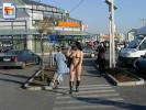 Hot chick crossing the street fully nude near some shops